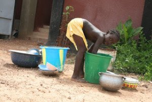 To clean the clothes and the plates, one of the responsibilities of one orphan girl living in a "taking in" family
